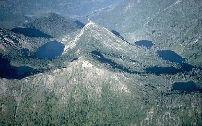 Aerial photo of Jewel Basin, a forested ridgeline in the Swan Range with alpine lakes below