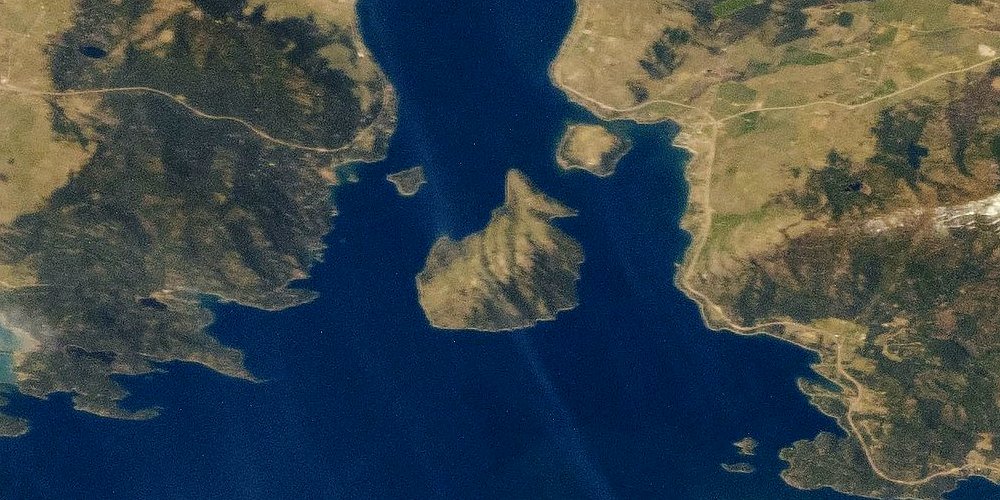 Wild Horse Island seen from orbit, a wedge-shaped island at the mouth of Big Arm Bay